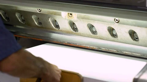 Man cutting paper with big paper cutter machine Stock Footage 120900945