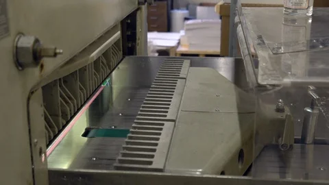 Man cutting paper with big paper cutter machine Stock Footage 120901792
