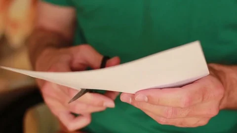 Man cutting paper with scissors 動画素材 74292121