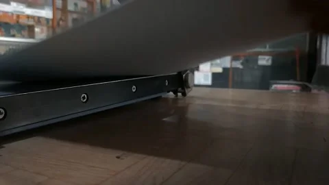 A man is cutting paper using a manual paper cutter at his desk 動画素材 202236158