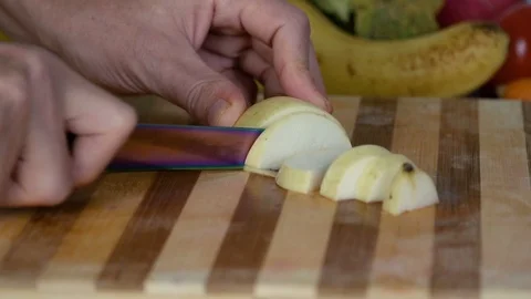 Man is cutting pear on cutting board Stock Footage 98201187