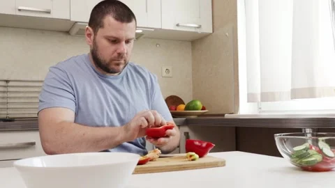 Man cutting pepper in the kitchen, middle-aged person cooking dinner, fresh.. Stock Footage 298244045
