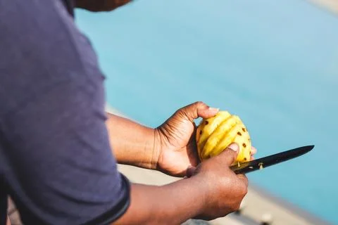 Man Cutting Pineapple with Precision. Fresh Pineapple Delight Stock Photos