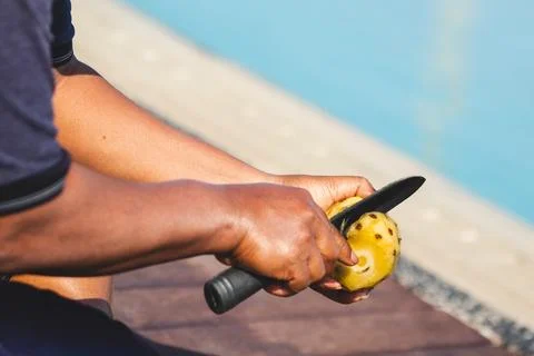 Man Cutting Pineapple with Unique Style. Tropical Fruit Art. Stock Photos