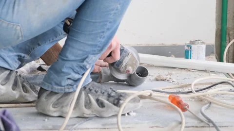 Man cutting a pipe with an electrical saw Stock Footage 238534417