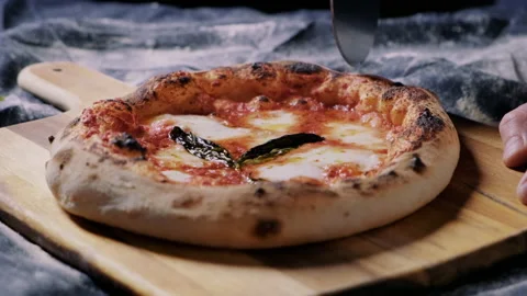 Man cutting pizza into slices Stock Footage 132837445