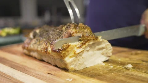 Man cutting pork with sharp knife on chopping board Stock Footage 101283101