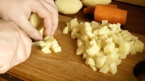 Man is cutting potatoes Stock Footage 78304458