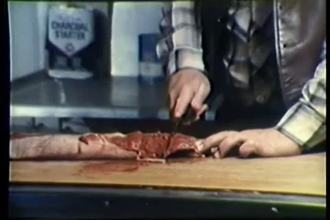 Man cutting raw meat on counter in restaurant kitchen Stock Footage 11354346
