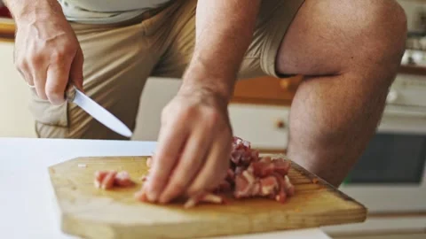 Man cutting raw pork meat on a wooden board Stock Footage 321278897