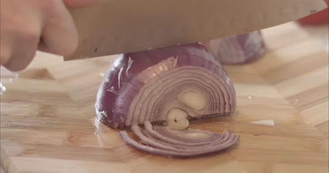 Man cutting red or purple onion with chef's knife Stock Footage 155544722