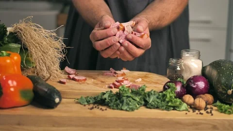 Man is cutting the sausage on the board between the vegetables Home-made sausage Video stock 141601866