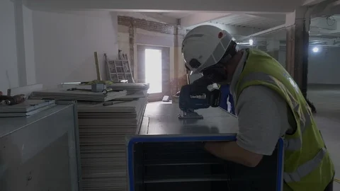 Man Cutting Sheet Metal Using A Jig Saw In Industrial Unit Video stock 92689916