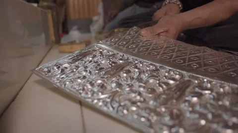 Man cutting a silver plate for temple Stock Footage 219611243