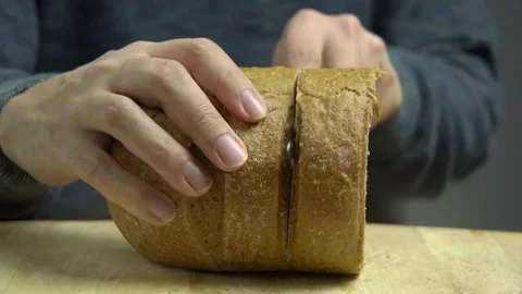 Man Cutting Slice of Freshly Baked Bread with Knife, Studio Video stock 76522081