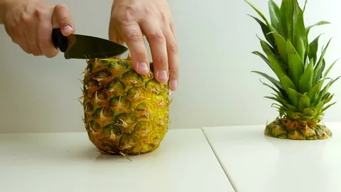 Man cutting slicing pineapple Stock Footage 75498854