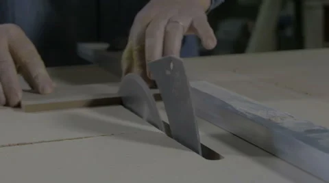 Man cutting small board on circular table saw in workshop, hands close up. Stock Footage 57739916