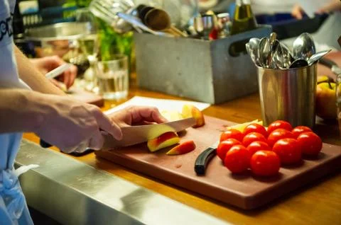 A man is cutting spring red tomatoes Stock Photos