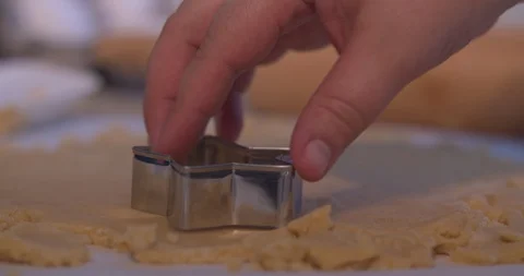 Man Cutting a Star Shaped Cookie out of Cookie Dough Stock Footage 101053278