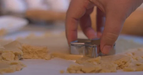 Man Cutting a Star Shaped Cookie out of Cookie Dough Stock Footage 101053557
