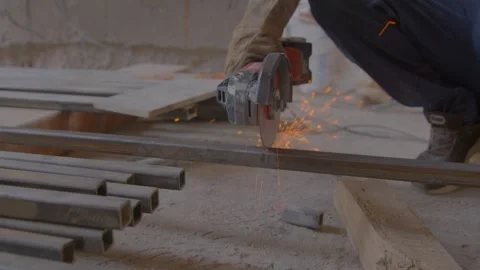 Man cutting steel square pipe and grinder door pipes Stock Footage 286959940