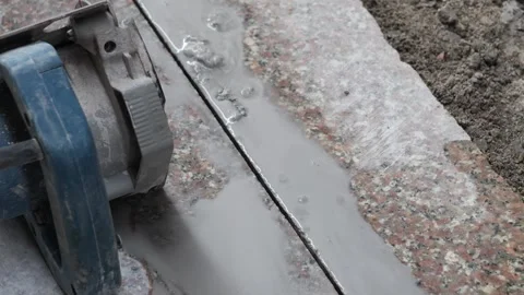 Man cutting stone with machine at construction site in India Видео 319074246