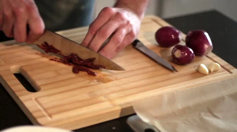 A man is cutting a tomato into slices Stock Footage 50448346
