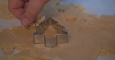 Man Cutting a Tree Shaped Cookie out of Cookie Dough Stock Footage 101054098