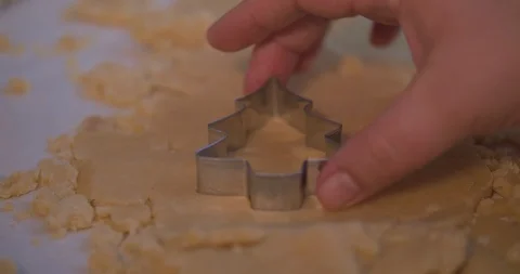 Man Cutting a Tree Shaped Cookie out of Cookie Dough Stock Footage 101054387