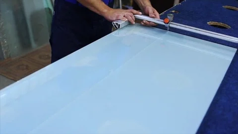 Man cutting a triplex glass in the workshop Stock Footage 69916361
