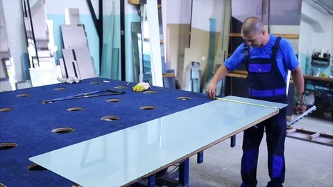 Man cutting a triplex glass in the workshop Stock Footage 69917441