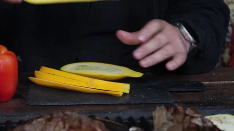 Man cutting vegetables for grilling on black board close-up Stock Footage 280409075