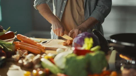 Man cutting vegetables in the kitchen Stock Footage 311834940