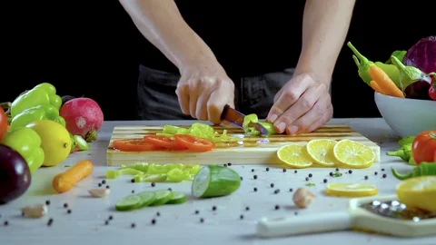 Man is cutting vegetables in the kitchen, slicing green bell pepper Stock Footage 98201473