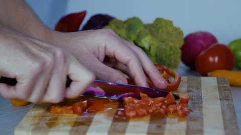 Man is cutting vegetables in the kitchen, slicing tomato closeup footage Stock Footage 98201719