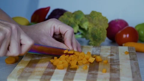 Man is cutting vegetables in the kitchen, slicing carrot, closeup view Stock Footage 98201911