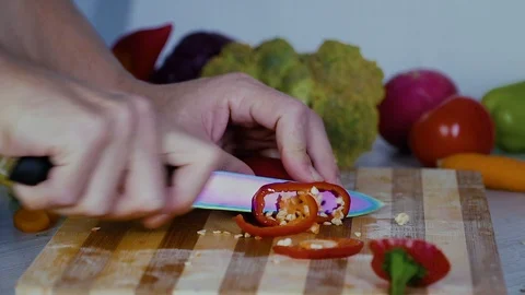 Man is cutting vegetables in the kitchen, slicing red bell pepper Stock Footage 98201955