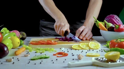 Man is cutting vegetables in the kitchen, slicing red cabbage Stock Footage 98202034