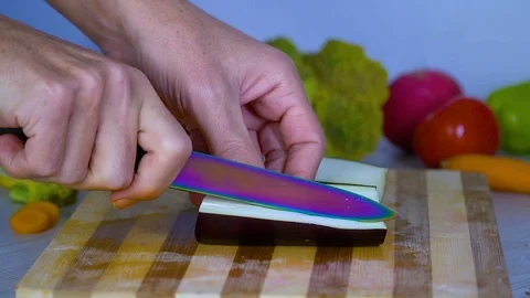 Man is cutting vegetables in the kitchen, slicing eggplant Stock Footage 98202556