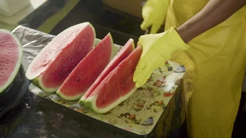 Man Cutting Watermelon in Slices Stock Footage 106556570