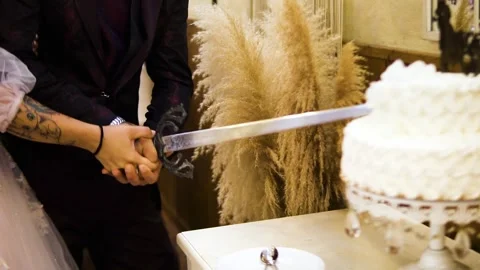 Man cutting a wedding cake with a Stock Video Pond5