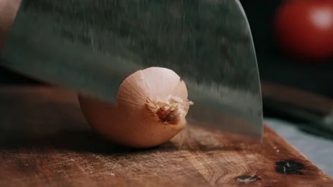 Man Cutting A White Onion In The Kitchen Video stock 134417876