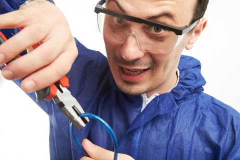 Man cutting wire Stock Photos