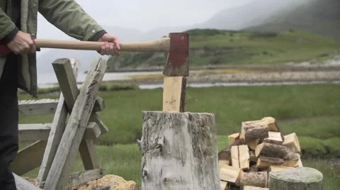 Man cutting wood with axe Stock Footage 65964079