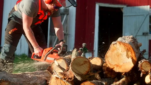 Man Cutting Wood With Chainsaw - Close Up Stock Footage 327767504