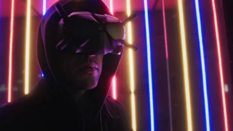 Man in cyberware vr glasses portrait with colorful neon lights in background Stock Footage 252382341