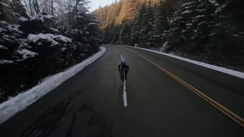 Man Cycling Up Mountain in Winter in Vancouver Stock Footage 71237666