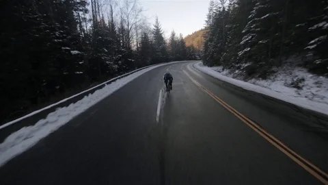 Man Cycling Up Mountain in Winter in Vancouver Stock Footage 71237778