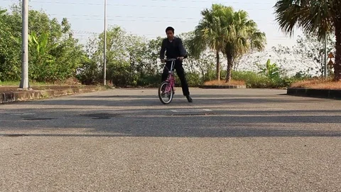 Man cycling on the road Stock Footage 72979351