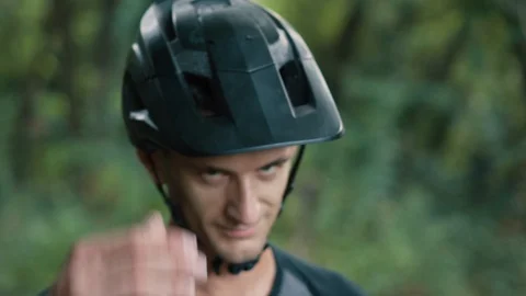 Man cyclist knocks his hand on helmet on his head Stock Footage 93365350